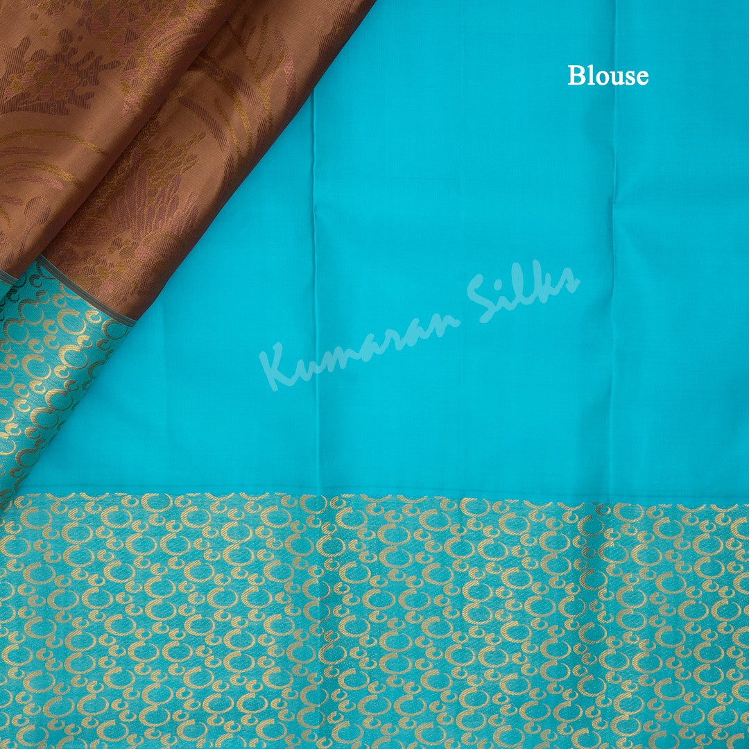 Brown Silk Saree With Floral Motif And Blue Border - Kumaran Silks