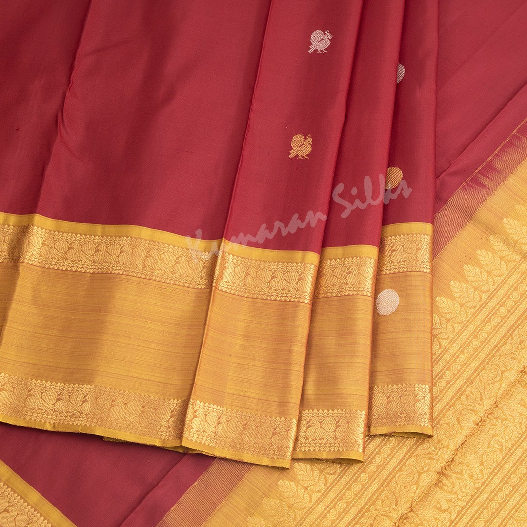 Maroon Silk Saree With Peacock And Chakra Buttas And Rettapet Border