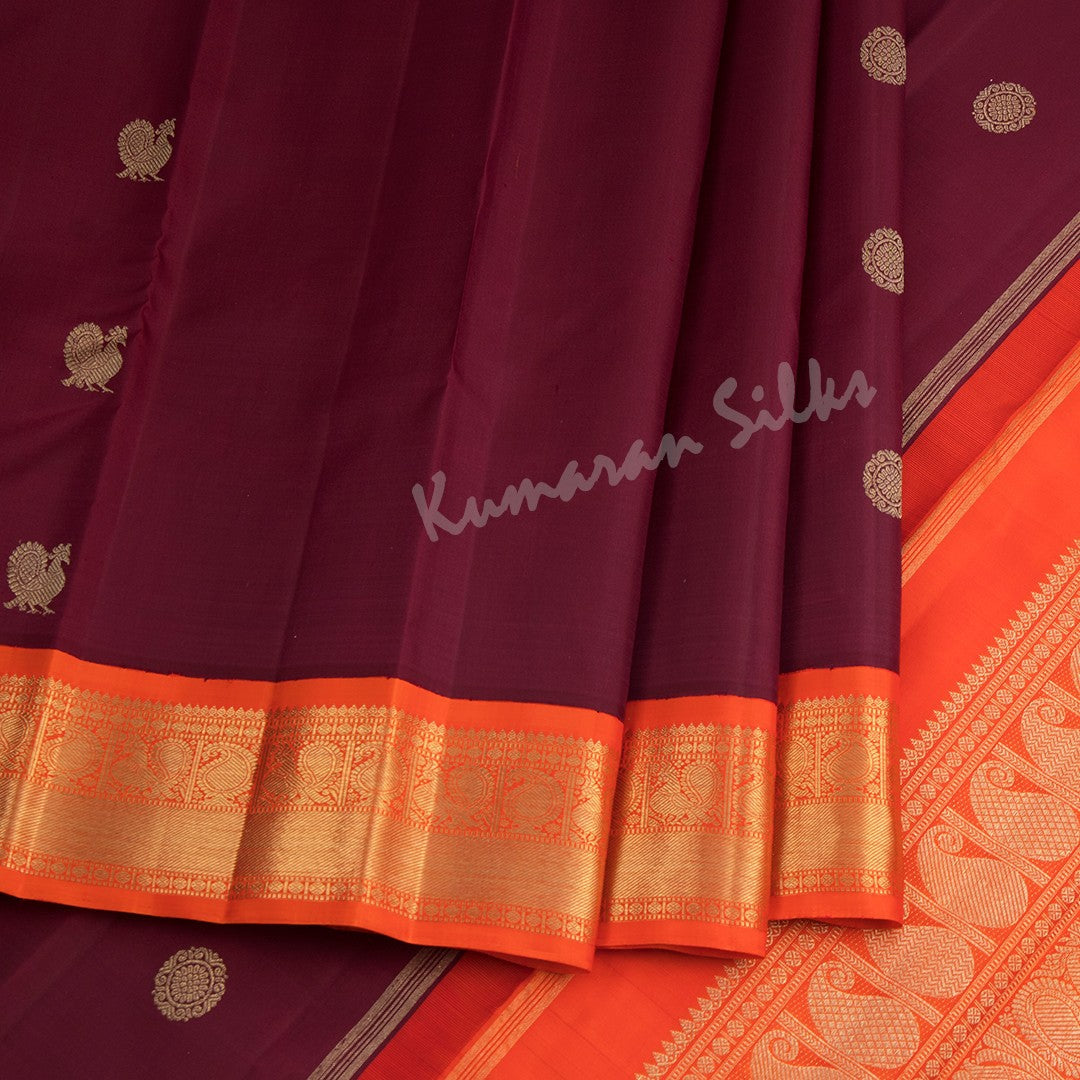 Maroon Silk Saree With Peacock And Chakra Buttas And Orange Zari Border