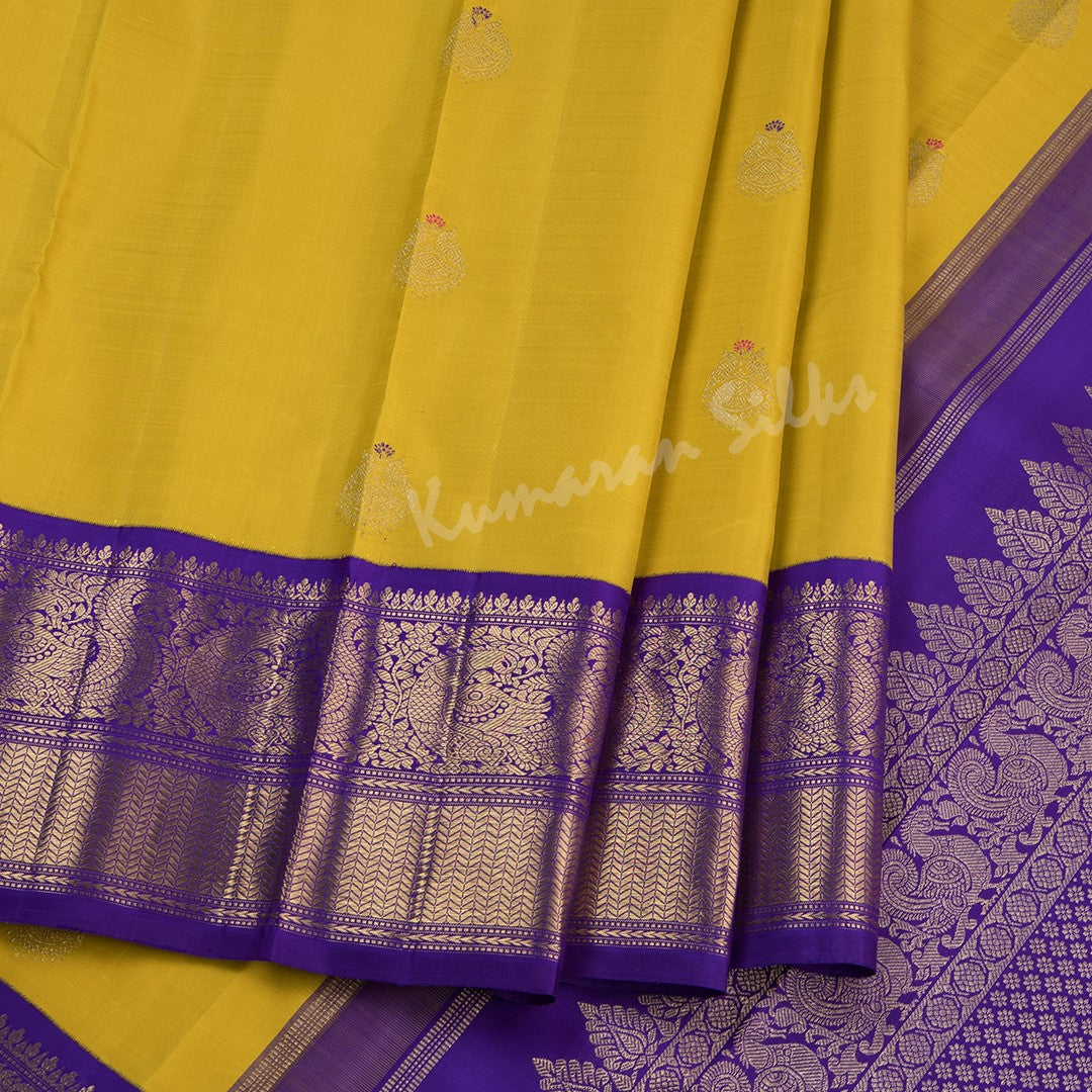 Mustard Yellow Silk Saree With Peacock Zari Buttas And Purple Zari Border